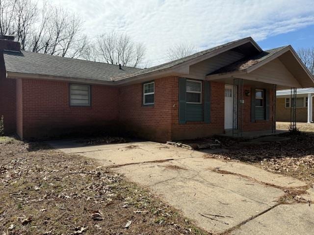 view of home's exterior with a chimney and brick siding