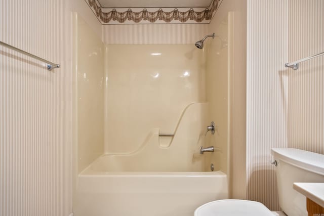 bathroom with shower / tub combination and toilet