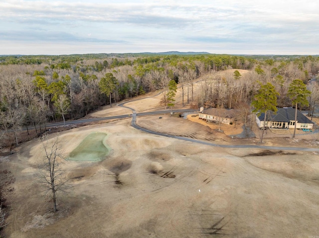 birds eye view of property featuring a view of trees