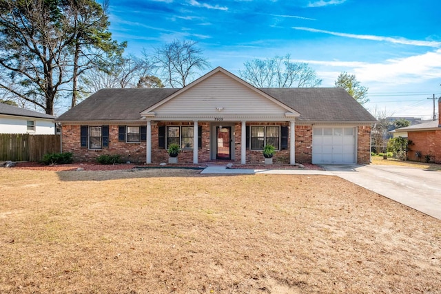 view of front facade with driveway, an attached garage, fence, a front lawn, and brick siding