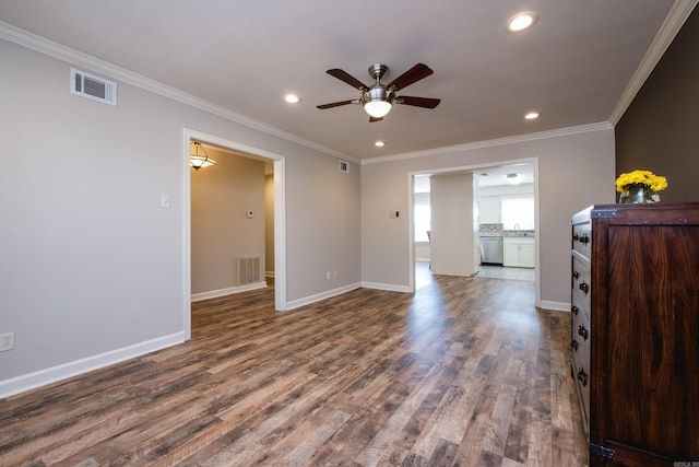 spare room with dark wood-style floors, baseboards, and crown molding