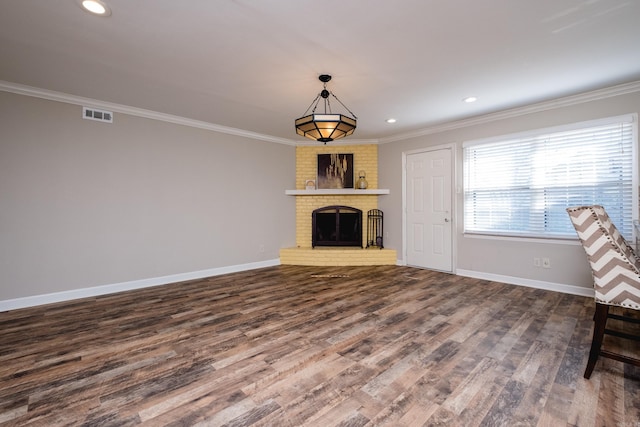 unfurnished living room with visible vents, crown molding, baseboards, and wood finished floors