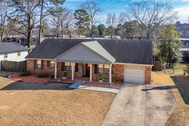 ranch-style house with a garage, driveway, fence, and brick siding