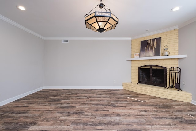 unfurnished living room with a fireplace, baseboards, crown molding, and wood finished floors