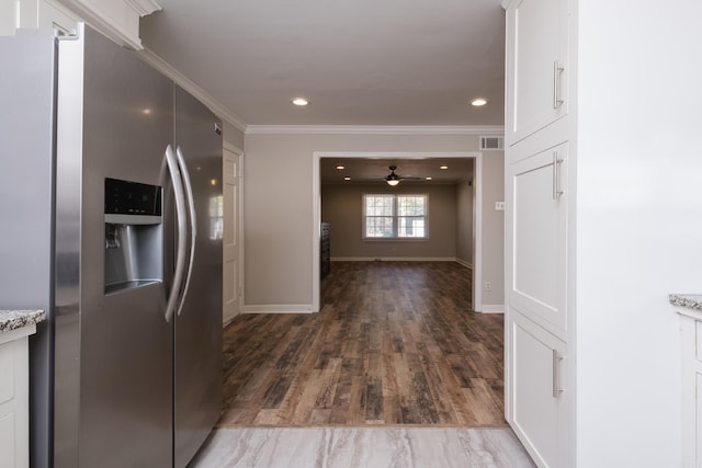 kitchen with ornamental molding, stainless steel refrigerator with ice dispenser, visible vents, and recessed lighting