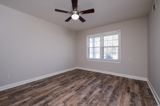 unfurnished room featuring visible vents, dark wood finished floors, baseboards, and ceiling fan