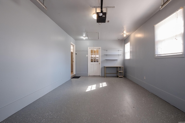 garage with baseboards and a garage door opener