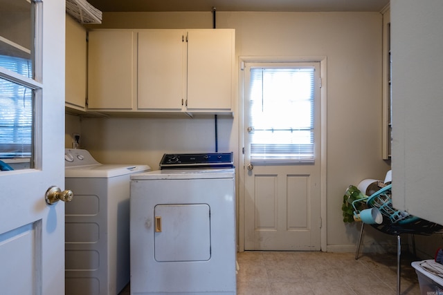 clothes washing area featuring cabinet space, washing machine and clothes dryer, and light tile patterned flooring