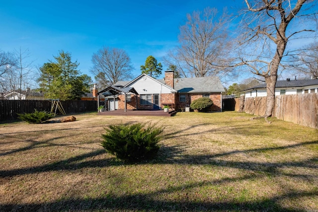 view of yard with a fenced backyard and a deck