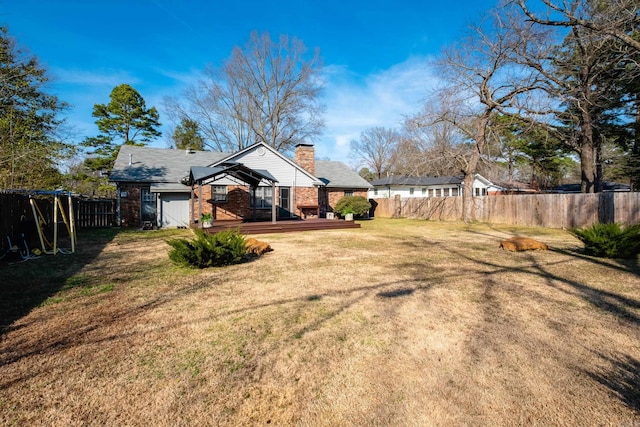 view of yard with a fenced backyard and a deck