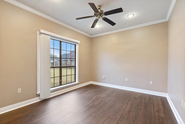 spare room featuring ornamental molding, dark wood finished floors, baseboards, and ceiling fan