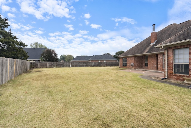 view of yard with a patio area and a fenced backyard