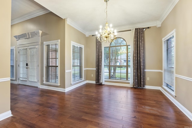 unfurnished dining area featuring baseboards, ornamental molding, a chandelier, and wood finished floors