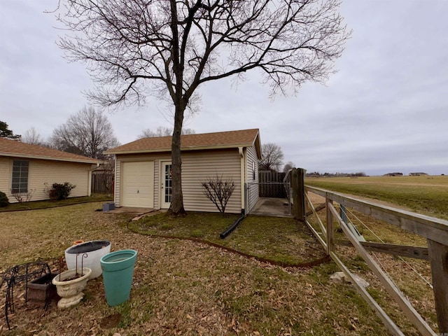 exterior space with a yard, an outbuilding, and fence