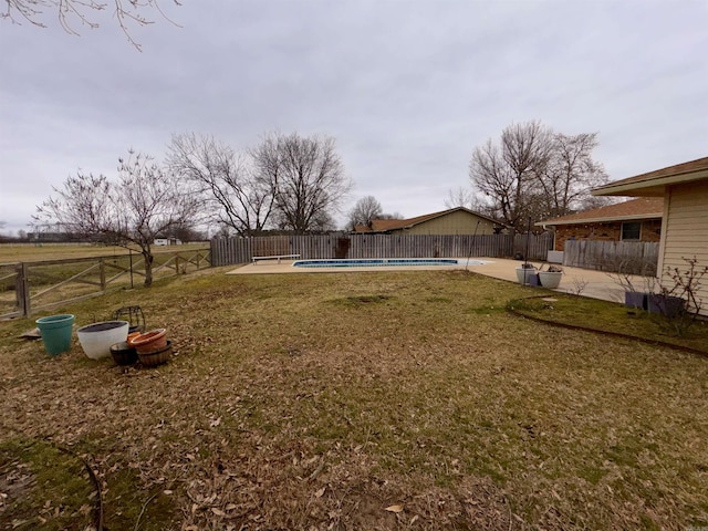 view of yard with a patio area, a fenced backyard, and a fenced in pool