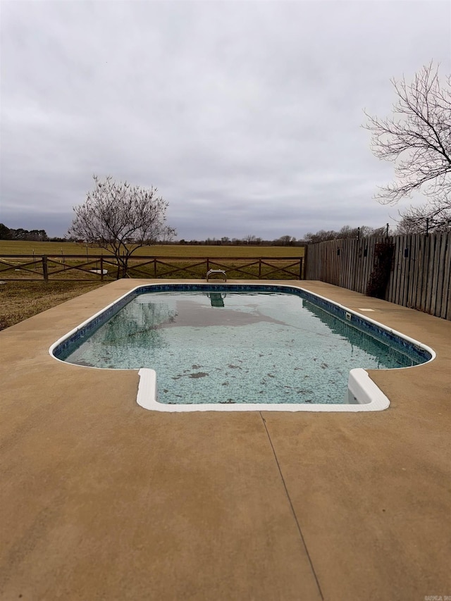 view of swimming pool featuring a patio area, fence, and a fenced in pool