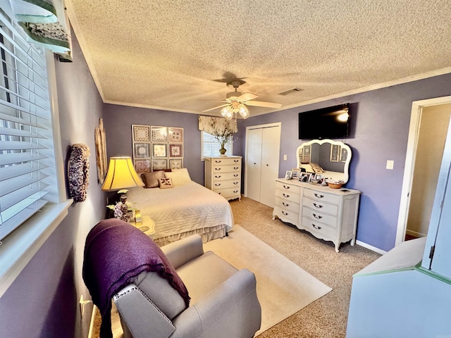 bedroom featuring a textured ceiling, visible vents, and crown molding