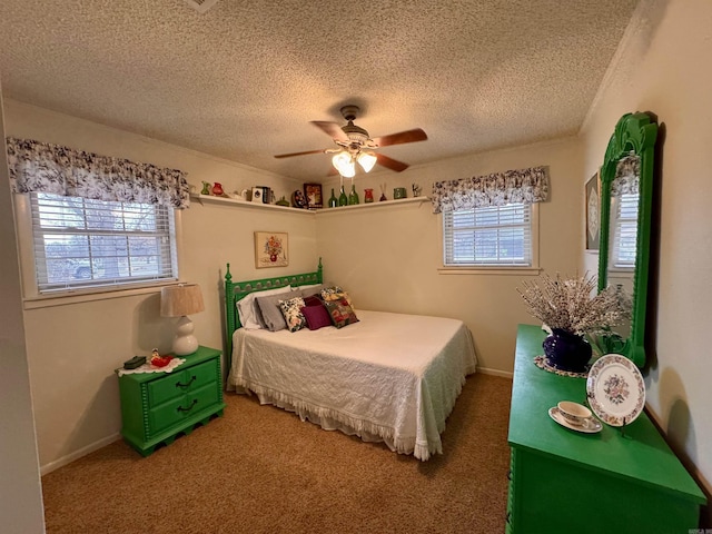 bedroom with ceiling fan, a textured ceiling, baseboards, and carpet flooring