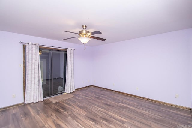 spare room with ceiling fan, wood finished floors, and baseboards