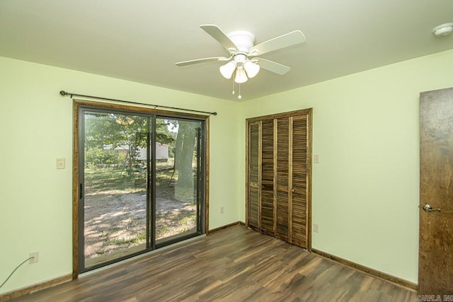 spare room with a ceiling fan, dark wood-style flooring, and baseboards