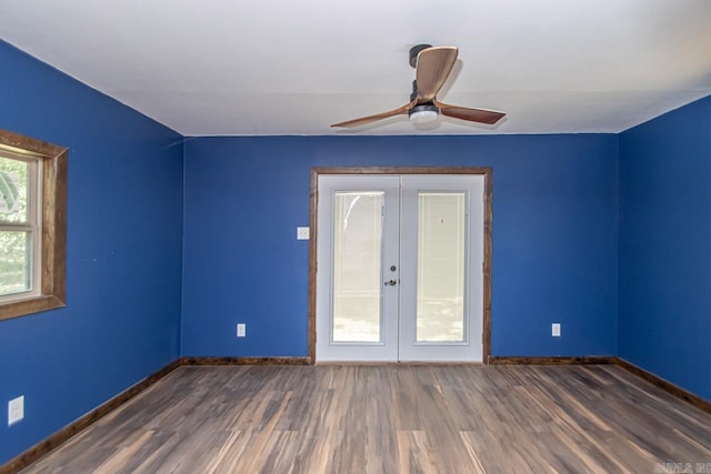 spare room featuring a ceiling fan, baseboards, wood finished floors, and french doors