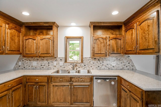 kitchen with tasteful backsplash, light countertops, dishwasher, and a sink