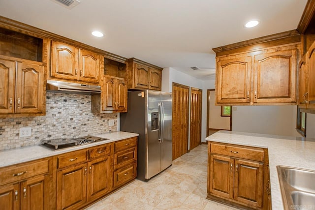 kitchen featuring under cabinet range hood, stainless steel appliances, light countertops, and brown cabinetry