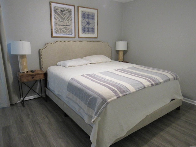 bedroom featuring baseboards and wood finished floors