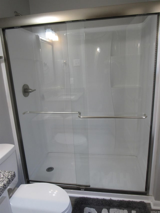 full bath with a shower stall and toilet