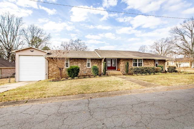 ranch-style house featuring a garage, concrete driveway, brick siding, and a front lawn