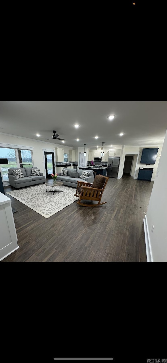 unfurnished living room featuring dark wood-style floors, a ceiling fan, and recessed lighting