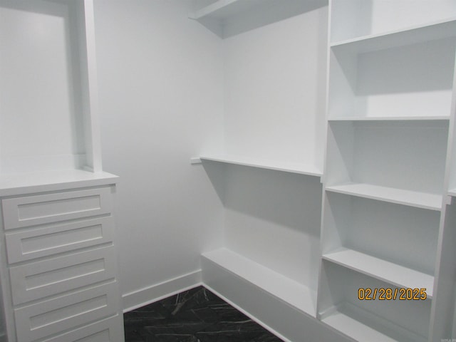 spacious closet featuring marble finish floor