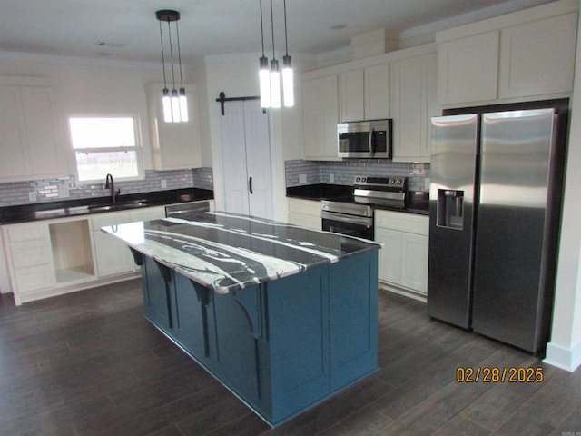 kitchen featuring stainless steel appliances, a sink, white cabinetry, tasteful backsplash, and crown molding