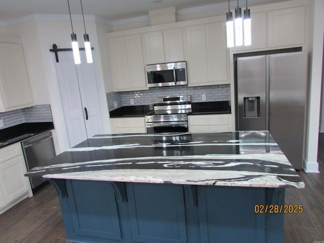 kitchen with appliances with stainless steel finishes, white cabinets, dark wood-type flooring, and backsplash