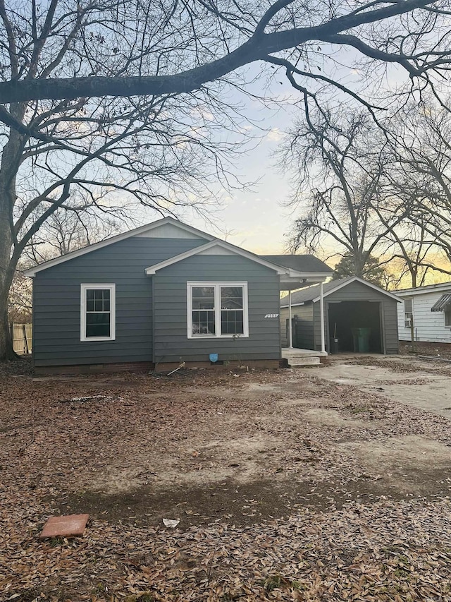 view of front of home with driveway and a carport