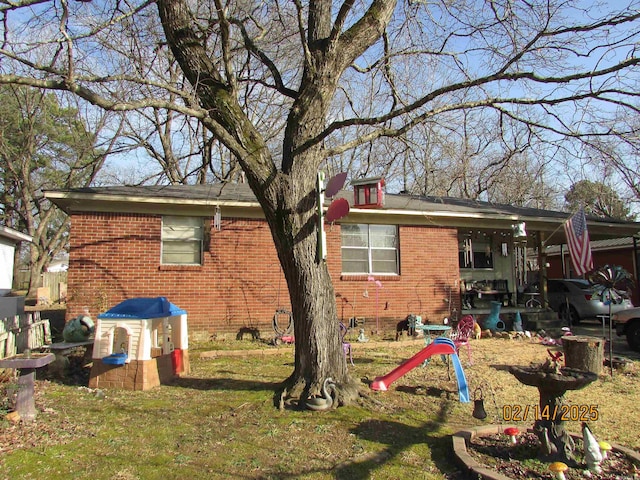 exterior space with a yard and brick siding