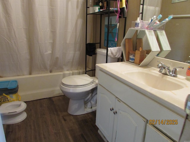 bathroom featuring shower / bath combo, vanity, toilet, and wood finished floors