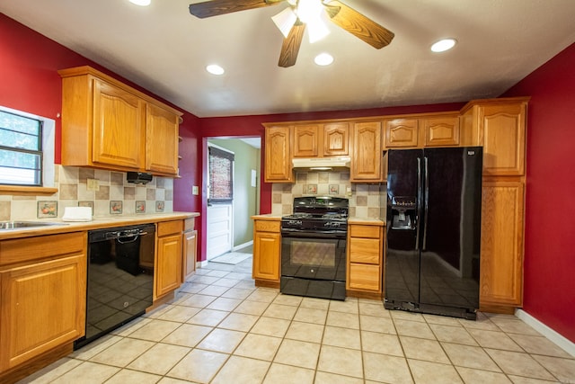 kitchen featuring light tile patterned floors, under cabinet range hood, baseboards, light countertops, and black appliances