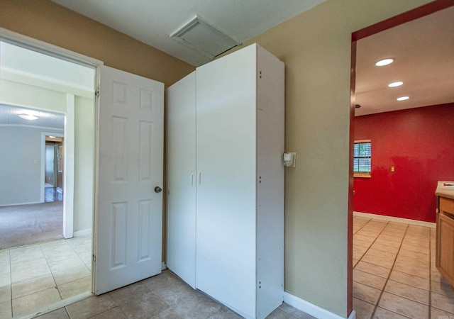 hallway with baseboards, light tile patterned flooring, attic access, and recessed lighting