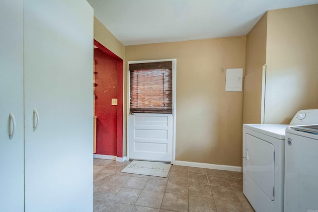 laundry area featuring laundry area, light tile patterned floors, baseboards, and separate washer and dryer