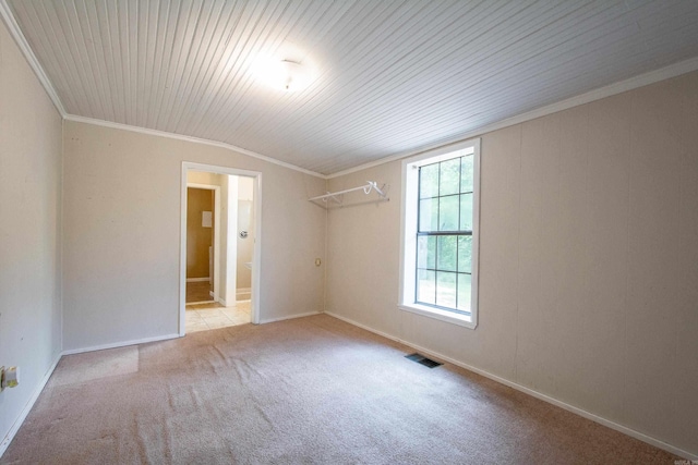 carpeted spare room with wooden ceiling, baseboards, visible vents, and crown molding