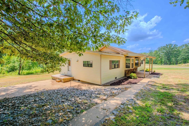 view of home's exterior featuring crawl space and a yard