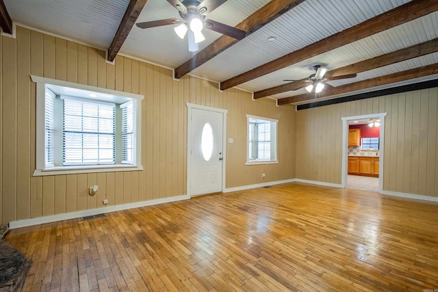 entryway with a healthy amount of sunlight, light wood-style floors, baseboards, and visible vents