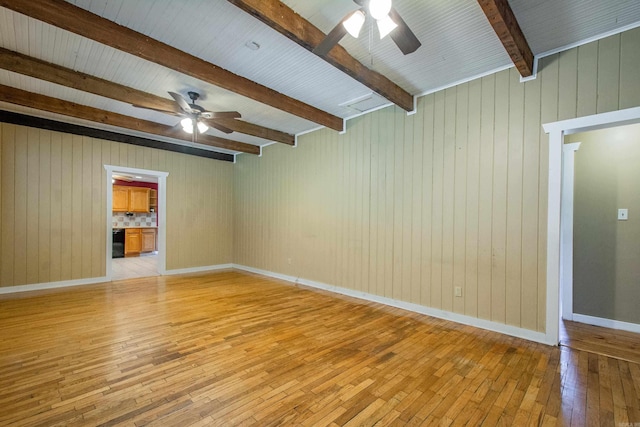 unfurnished room featuring light wood-type flooring, beam ceiling, ceiling fan, and baseboards