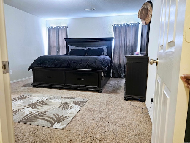 bedroom featuring carpet, visible vents, and baseboards