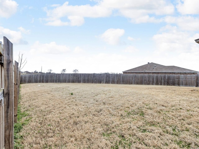 view of yard with a fenced backyard