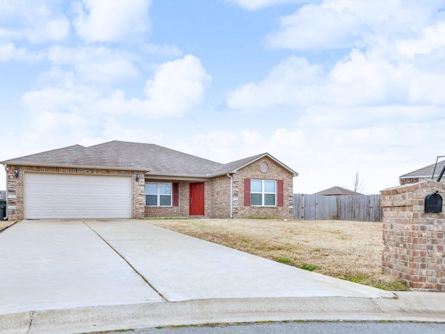 single story home featuring an attached garage, brick siding, fence, driveway, and roof with shingles