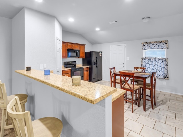 kitchen with recessed lighting, a peninsula, visible vents, brown cabinets, and black appliances