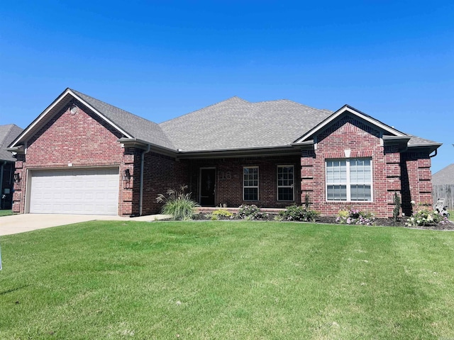 ranch-style house featuring a garage, driveway, a front lawn, and brick siding