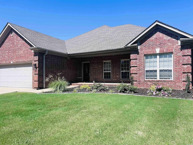 ranch-style home with a garage, brick siding, concrete driveway, roof with shingles, and a front yard